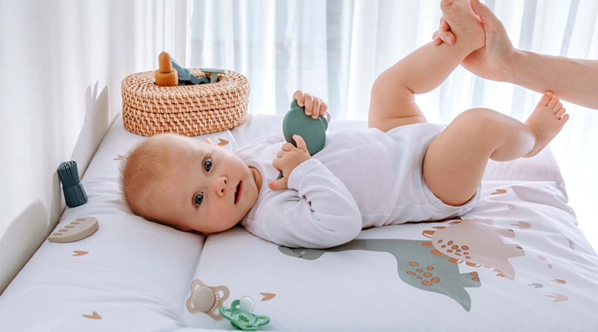Baby on changing mat changing-pad-baby-changing-pad-traeumeland