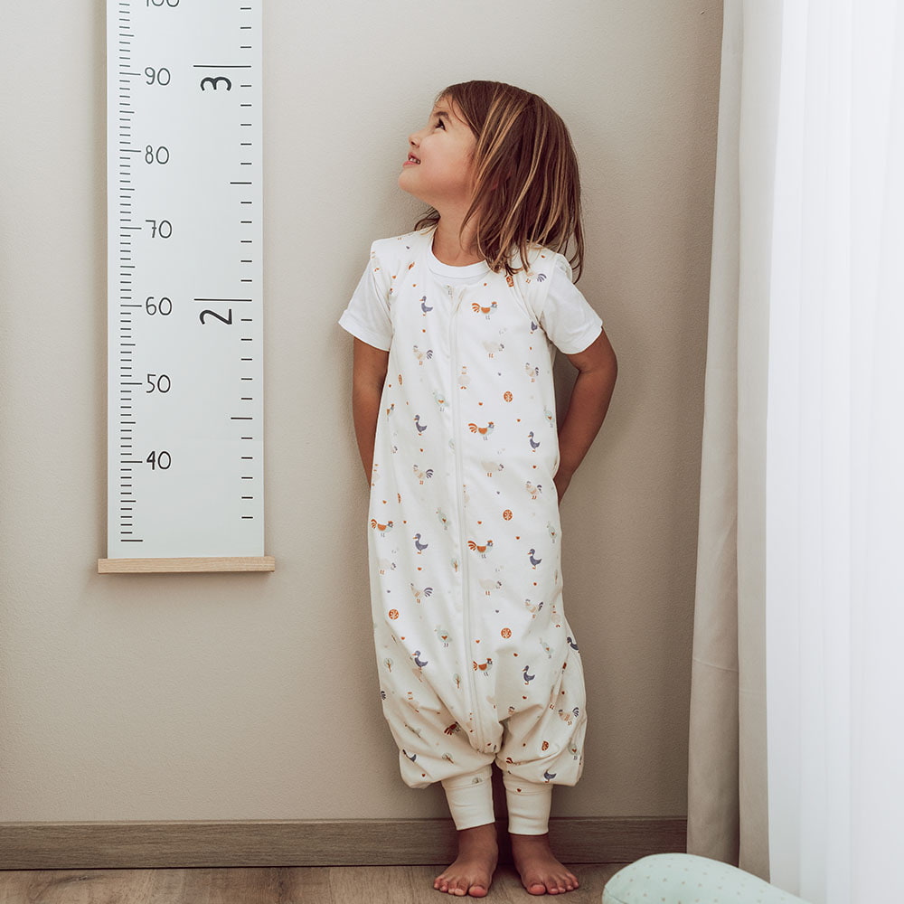 Child in Sleeping bag with feet in children's room Children's sleeping bag with feet with legs in children's room