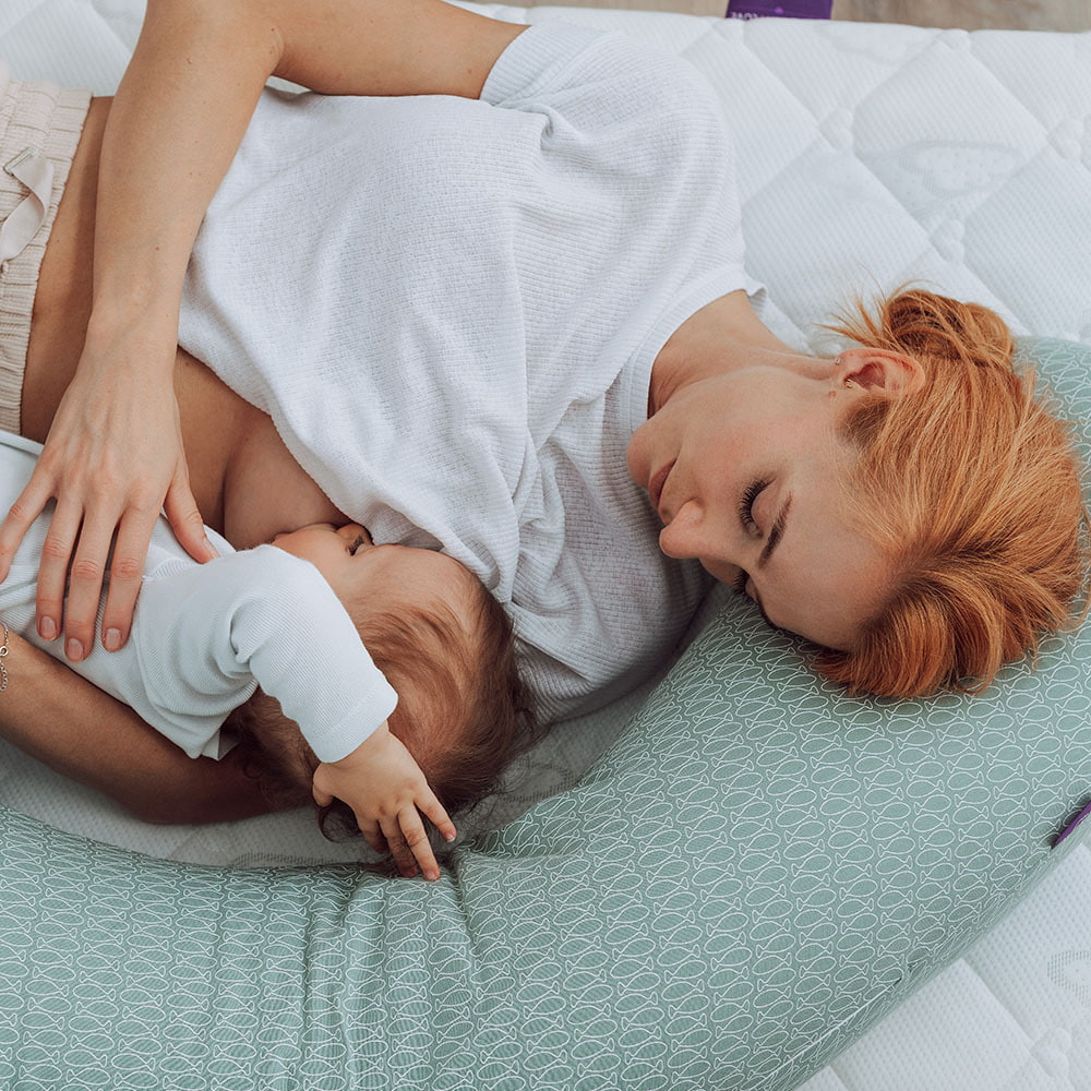 Mom breastfeeding with a nursing pillow